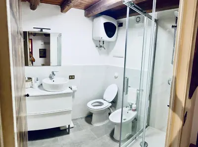 a bathroom with a toilet and a sink and a shower at Cala Costa in Palermo