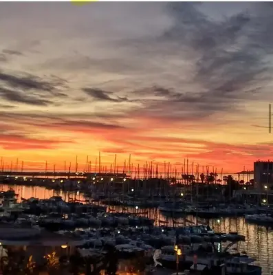 a group of boats in a marina at sunset at Cala Costa in Palermo