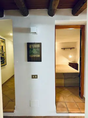 a room with a bed and a mirror at Cala Costa in Palermo