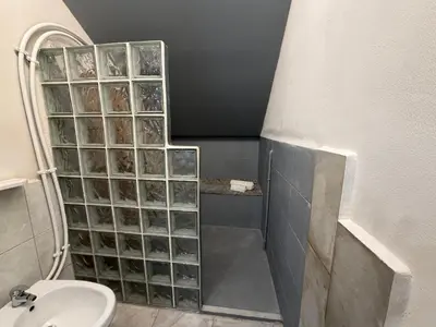 a bathroom with a shower and a toilet and a sink at A al Quadrato in Palermo