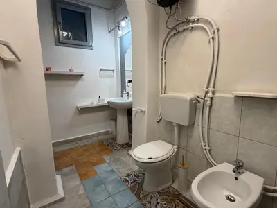a bathroom with a toilet and a sink at A al Quadrato in Palermo
