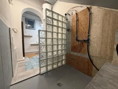 a bathroom with a shower with a glass wall at A al Quadrato in Palermo