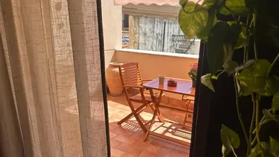 two bottles of essential oils and towels on a bed at Thalea Apartment in Palermo
