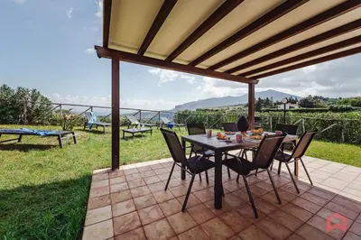 a small white house with a grass yard at Panoramic Villa with private Pool near Scopello in Scopello