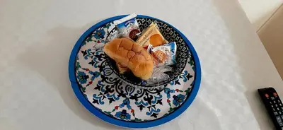 a blue and white plate with sandwiches and snacks on it at B&B Porta Nuova in Palermo