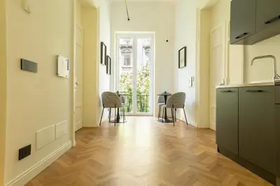 a hallway with a kitchen with a table and chairs at Limes in Palermo