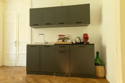 a kitchen with gray cabinets and a sink at Limes in Palermo