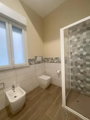 a bathroom with a toilet and a sink and a shower at Lucrezio Houses in Palermo
