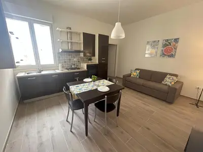 a living room with a table and a couch at Lucrezio Houses in Palermo