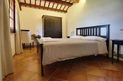 a bedroom with a large bed and a table at Poggio di mare in Castelluzzo