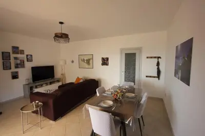 a living room with a couch and a table at Appartamento La Rosa dei Venti in Porticello
