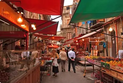 a group of people walking through an outdoor market at Casamori 2- nel cuore di Palermo, mercato Ballarò in Palermo