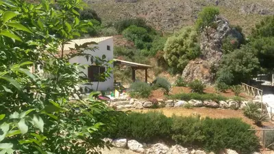 a house in the middle of a garden at Agave Scopello in Scopello
