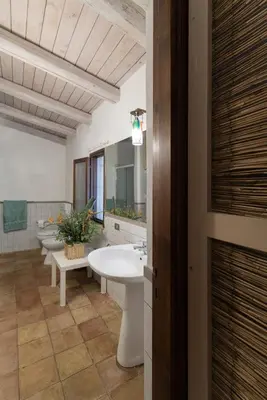 a bathroom with a sink and a row of toilets at Casa Ninfee, immersa nel verde con piscina in comune in Terrasini