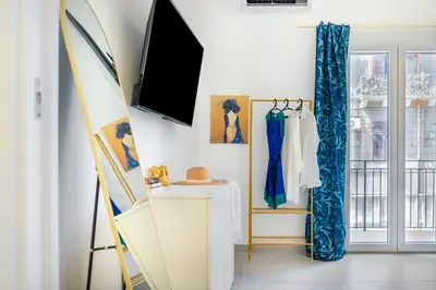 a living room with a surfboard and a tv on a wall at Colonna Secret, Private Jacuzzi in Historic Center in Palermo