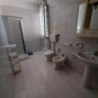 a bathroom with a toilet and a sink and a mirror at Maria Isabella appartament in Isola delle Femmine