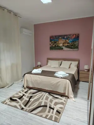 a bedroom with a bed with a painting on the wall at La casa di Anna e Lillo in Palermo