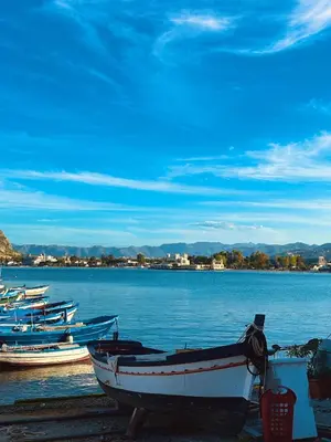a group of boats sitting on the shore of a lake at Ashur Mondello, sapore di sale in Palermo