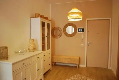 a kitchen with a white cabinet and a mirror at Ashur Mondello, sapore di sale in Palermo