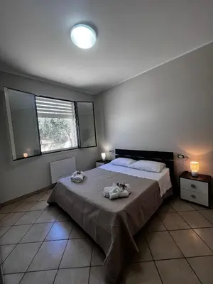 a bedroom with a large bed with two towels on it at West Sicily Beach in Balestrate