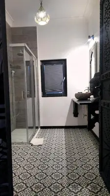 a bathroom with a shower with a glass door at zaraholiday24 in Palermo