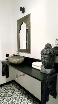 a bathroom with a sink and a statue on a counter at zaraholiday24 in Palermo