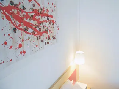 a bedroom with a painting on the wall at Bio Hotel Palermo in Palermo