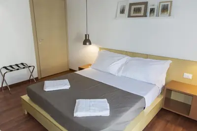 a bedroom with a bed with two towels on it at Bio Hotel Palermo in Palermo