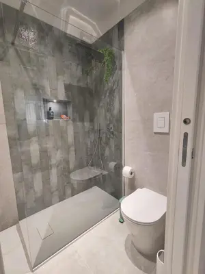 a small bathroom with a toilet and a shower at Molly house in Palermo