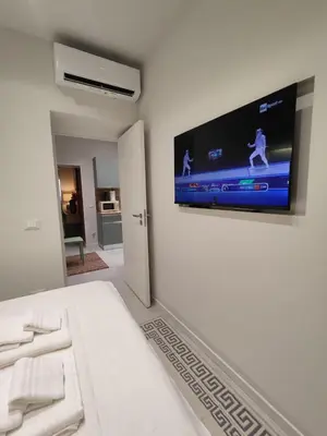 a bedroom with a bed with a flat screen tv on the wall at Molly house in Palermo