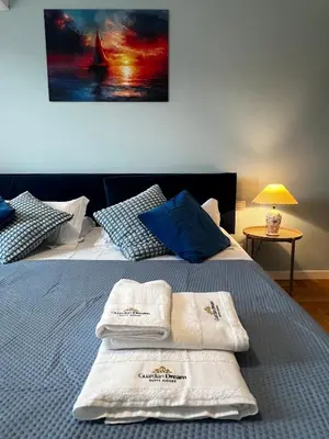 a bed with two towels on top of it at Guardian Dream Suite House nel cuore di Palermo in Palermo