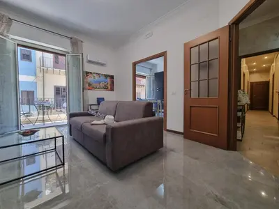 a living room with a couch and a glass table at Kala Flat by Holiday World in Palermo