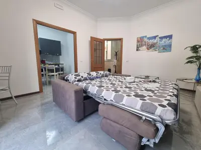 a living room with a bed and a couch at Kala Flat by Holiday World in Palermo