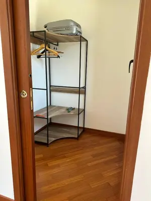 a room with a closet with a printer on a shelf at Villa Oasi Bonita a Mondello in Palermo
