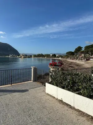a fence with a flower pot on it next to a body of water at Villa Oasi Bonita a Mondello in Palermo