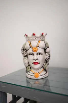 a statue of a mask on a table at Il Palchetto in Palermo