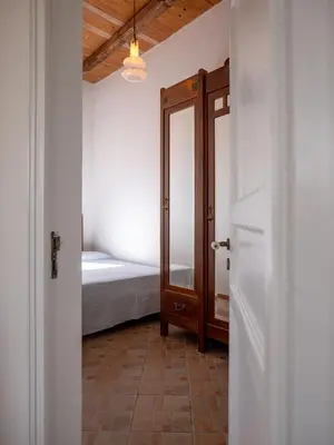 a bedroom with a bed and a door with a mirror at Locanda Lupo in Palermo