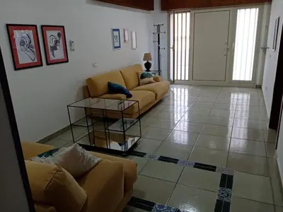 a living room with two couches and a table at Casa Montalbano in Nuova Gibellina