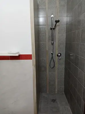 a shower in a bathroom with a glass door at Casa Montalbano in Nuova Gibellina