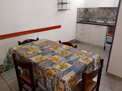 a kitchen with a table with a quilt on it at Casa Montalbano in Nuova Gibellina