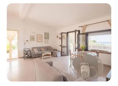 a living room with a couch and a table at Cas'aMare Holidays, Home is Love in Castellammare del Golfo