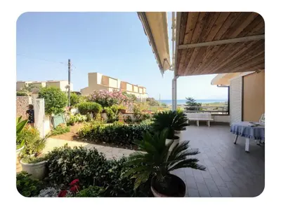a view of a patio with a table and plants at Cas'aMare Holidays, Home is Love in Castellammare del Golfo