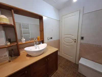 a bathroom with a white sink and a mirror at Emily's Place in Palermo