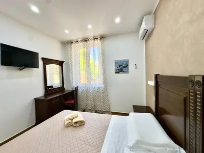 a bedroom with two beds and a television in it at MD Apartament Coral Bahalara 2 in Palermo
