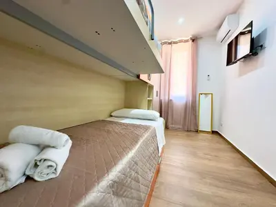 a bedroom with two beds with towels on them at MD Apartament Coral Bahalara 2 in Palermo