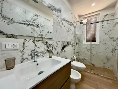 a bathroom with a white sink and a toilet at MD Apartament Coral Bahalara 2 in Palermo