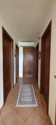 a hallway with two doors and a rug on the floor at Villa Calatafimi Segesta in Calatafimi