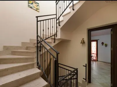 a staircase in a home with a black railing at Indipendente a S vito lo Capo in San Vito lo Capo