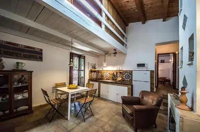 a kitchen with a table and chairs in a room at Casa Laghetto in the countryside with a shared pool in Terrasini