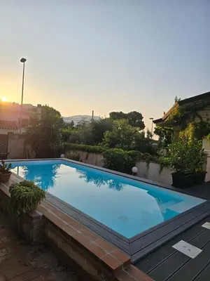 a large blue swimming pool in a backyard at LuminHouse Addaura Pool in Palermo